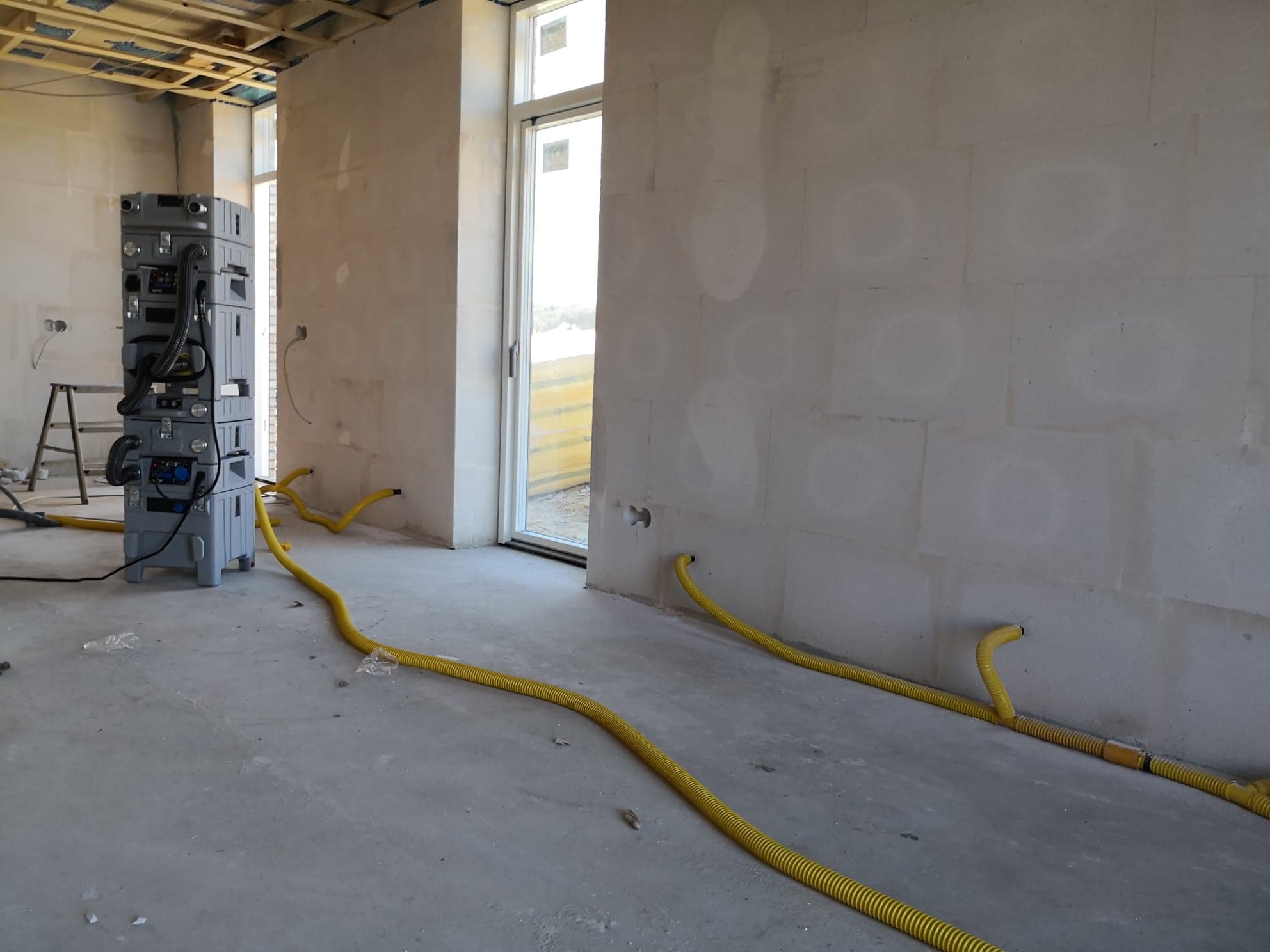 Aercube vacuum drying system drilled into walls ready for water damage drying